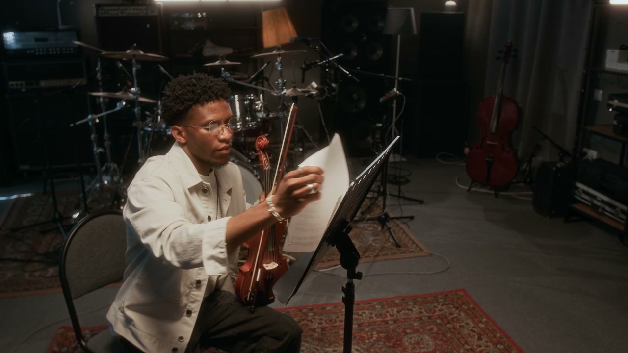 Young Man Playing Violin in Music Studio