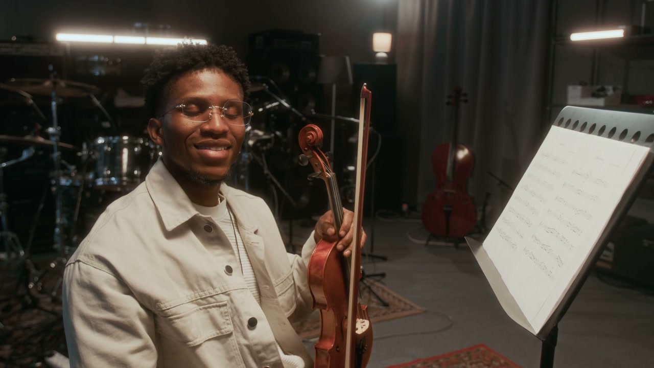 Male Violinist Smiling with Instrument in Studio
