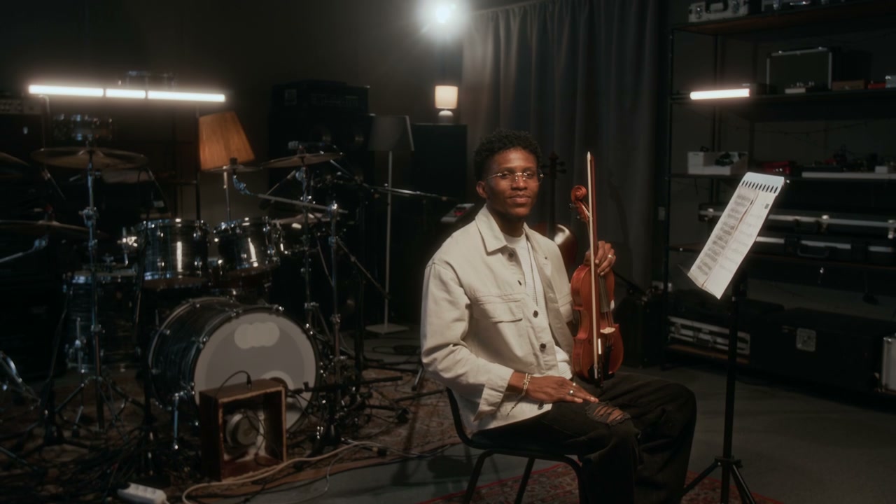 Smiling Young Man with Violin in Studio