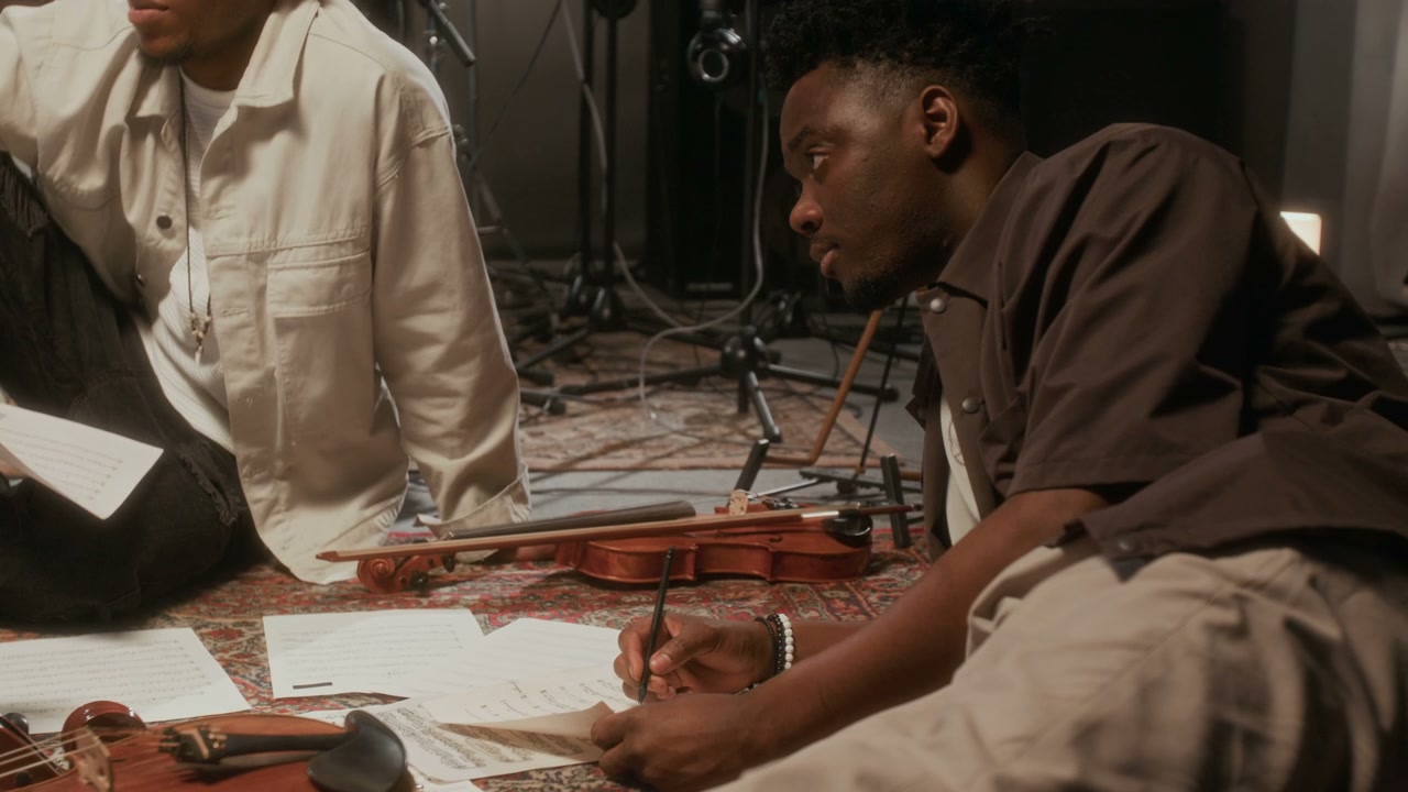 Musicians Composing Sheet Music in Studio