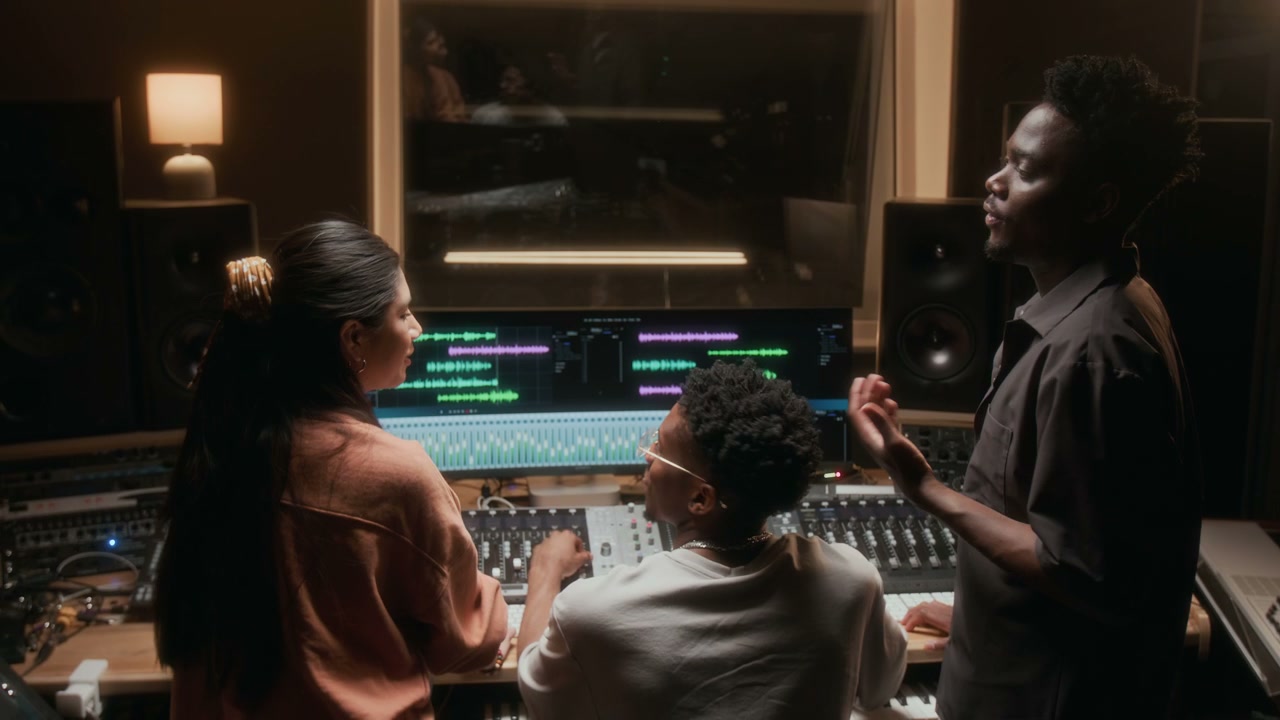 Music Producers Collaborating in Recording Studio