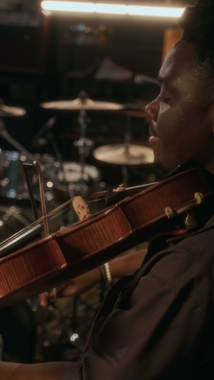 Man Playing Violin in Music Studio