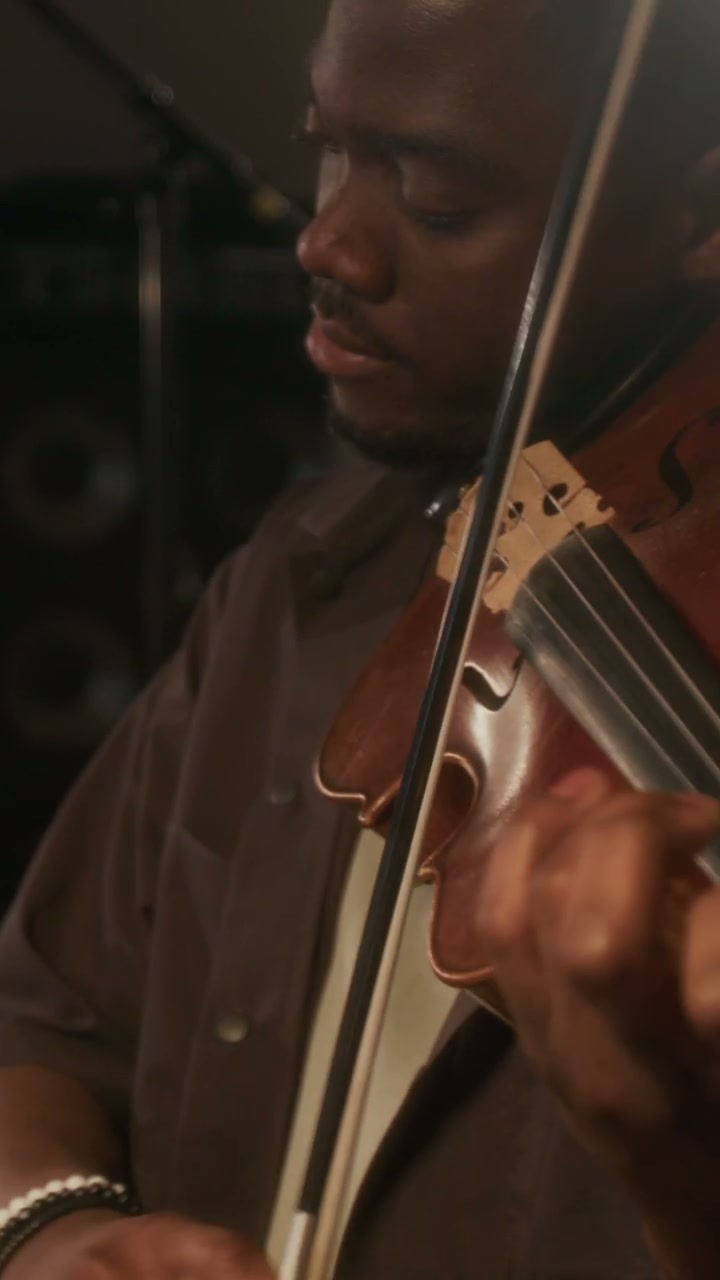Focused Man Playing Violin in Studio
