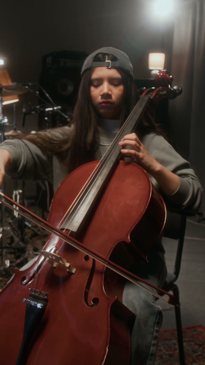 Young Woman Playing Cello in Studio