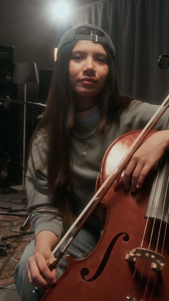 Cellist Looking at Camera in Studio