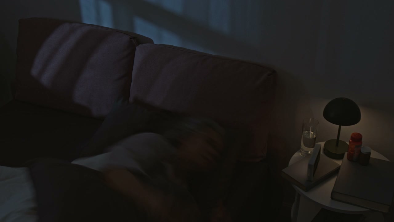 Senior Woman Struggling to Sleep in Bed at Night
