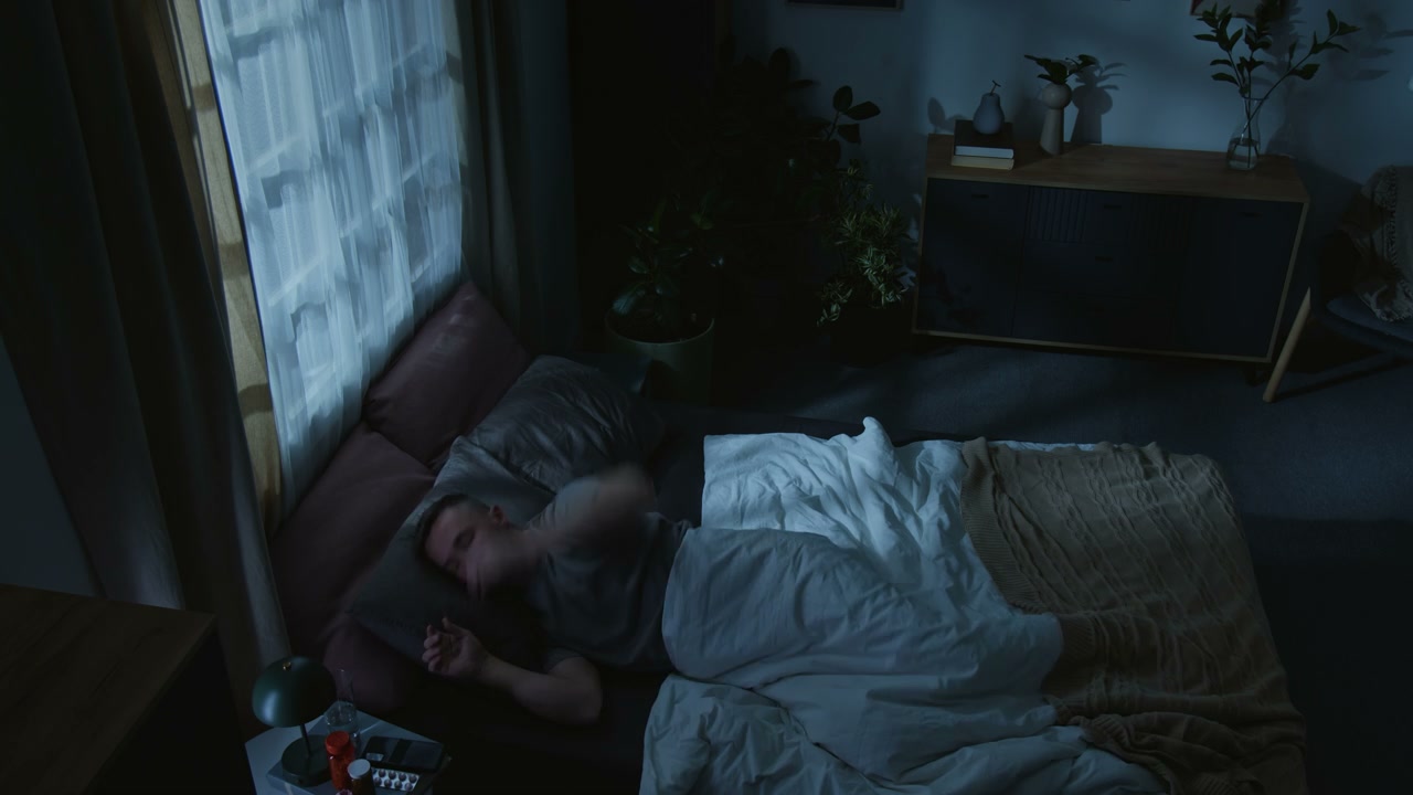 Man Struggling to Sleep in Bed at Night
