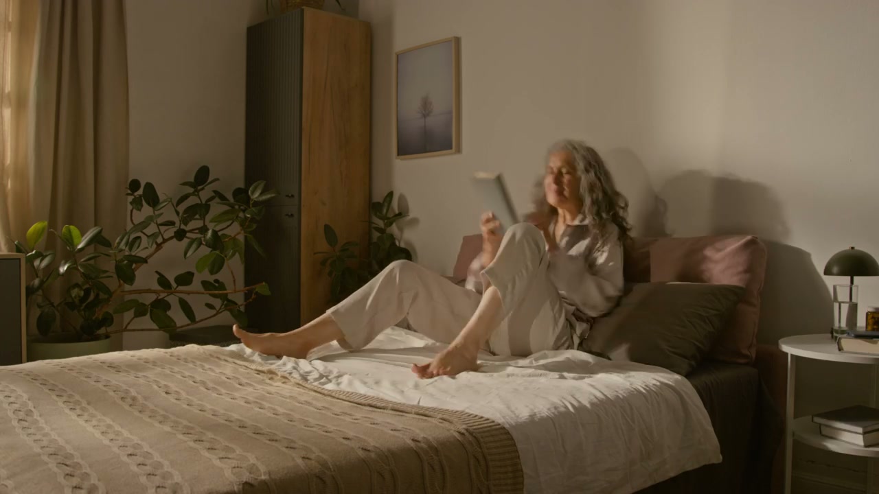 Time-Lapse of Senior Woman in Bed with Insomnia