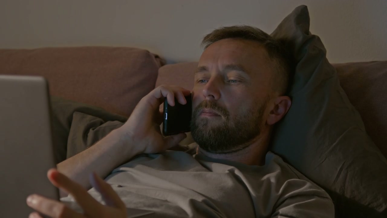 Man Working on Laptop in Bed at Night Time Lapse