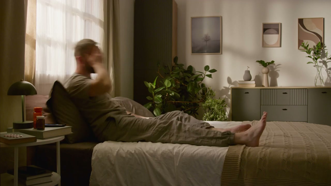 Man Wakes Up and Works From Bed in Morning