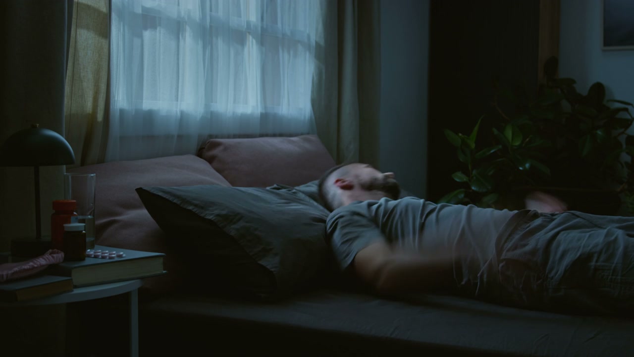 Time Lapse of Man with Insomnia in Bed