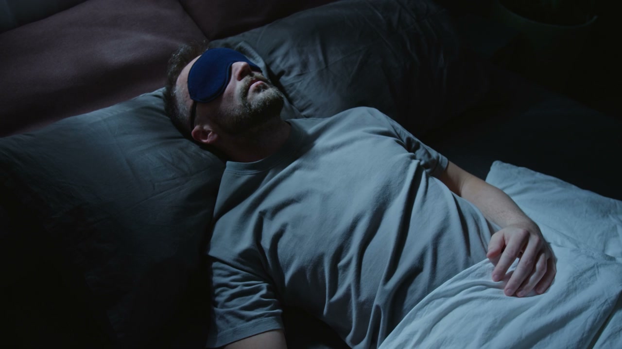 Man Sleeping with Eye Mask in Bed