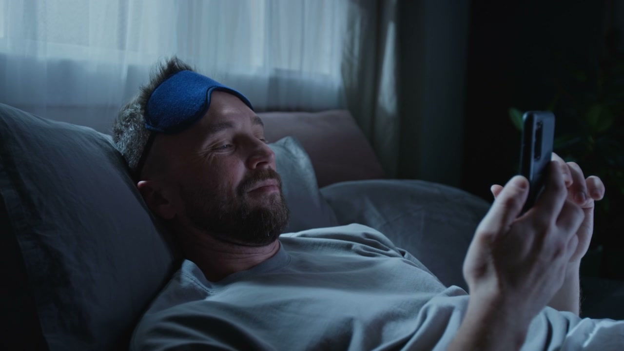 Man in Bed Using Phone Then Goes to Sleep