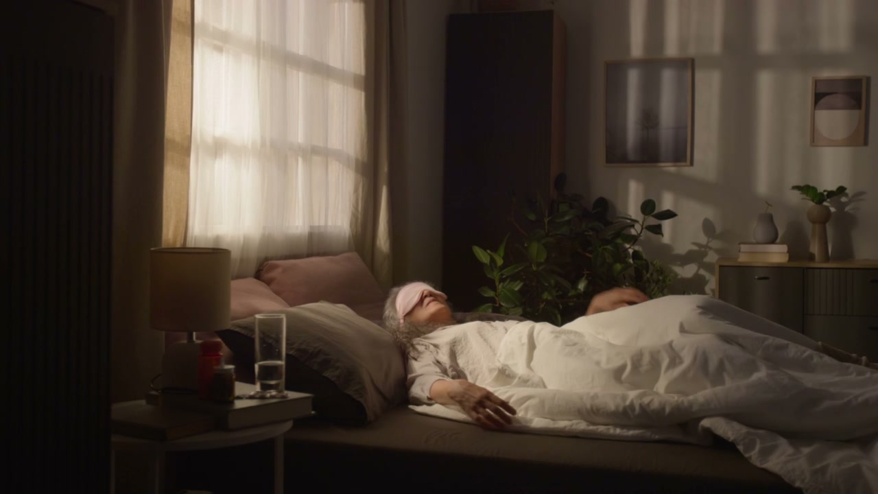 Senior Woman Sleeping in Cozy Bedroom