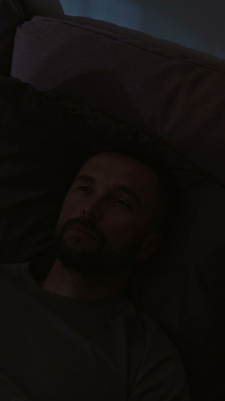 Man Lying Awake in Bed