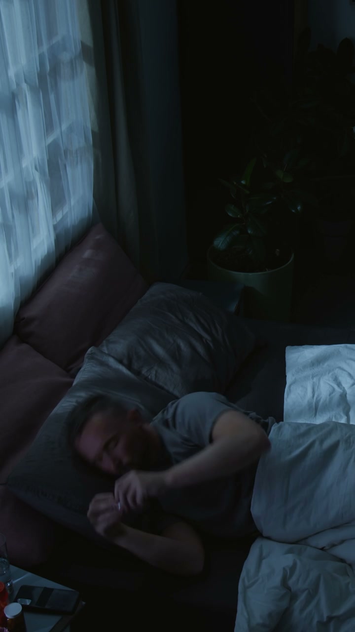 Restless Man in Bed at Night with Phone
