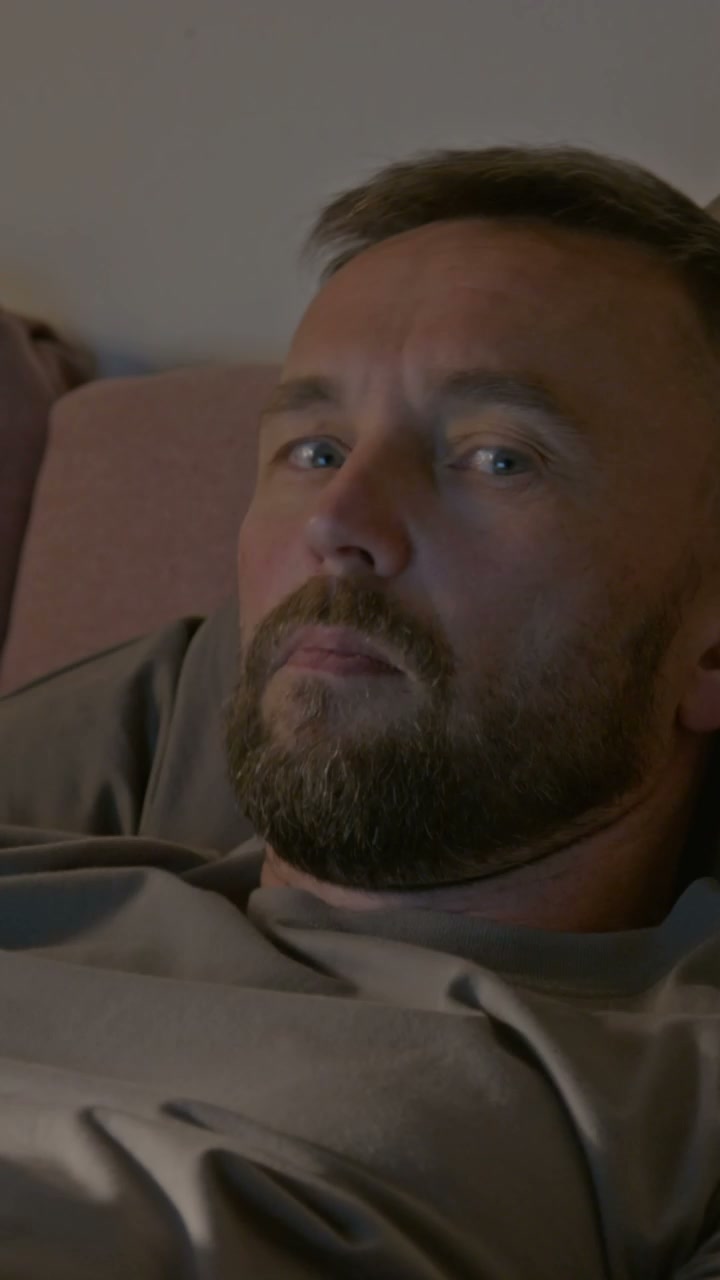 Man Using Smartphone in Bed at Night