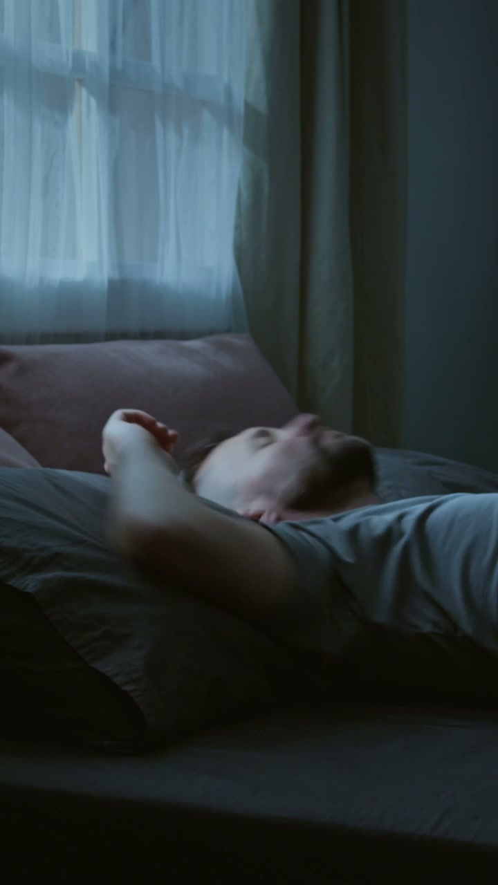 Man Tossing and Turning in Bed at Night