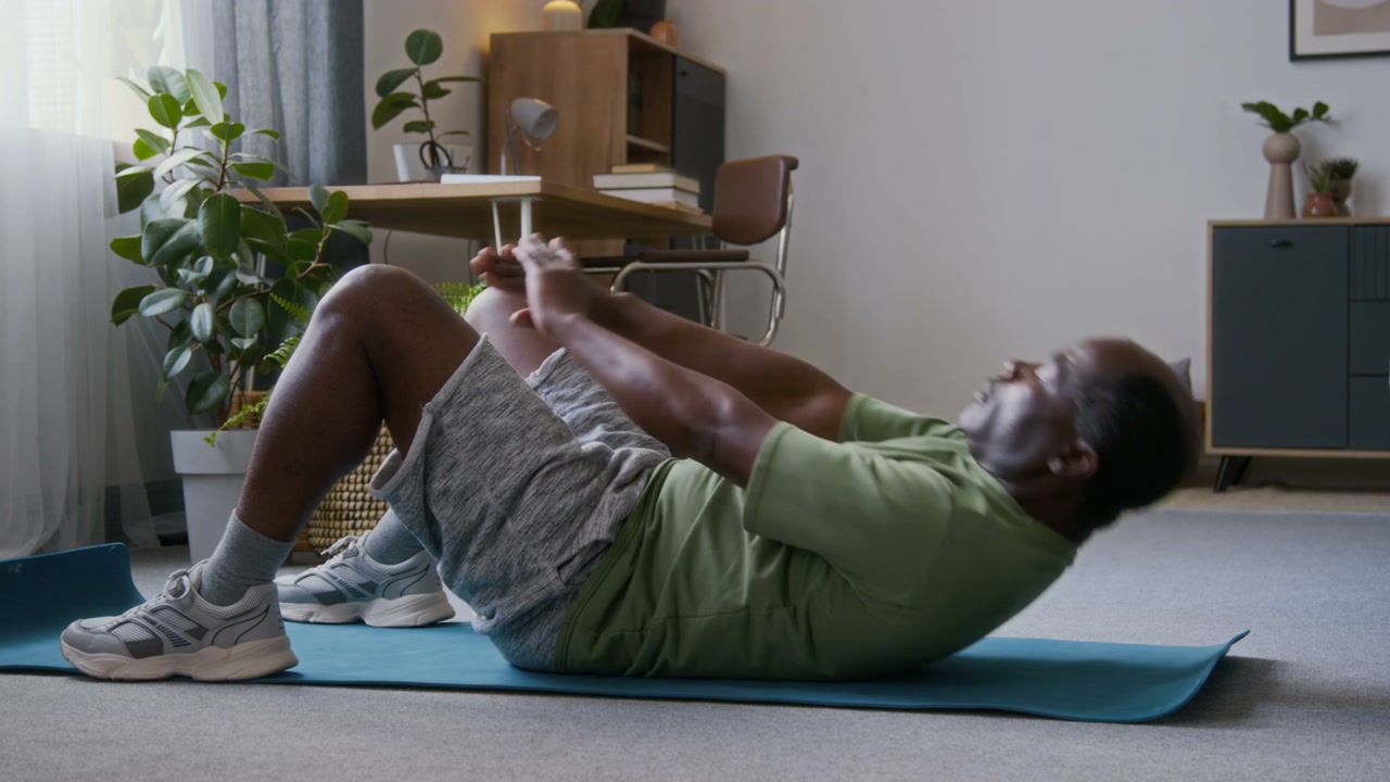 Senior Man Doing Crunches on Yoga Mat