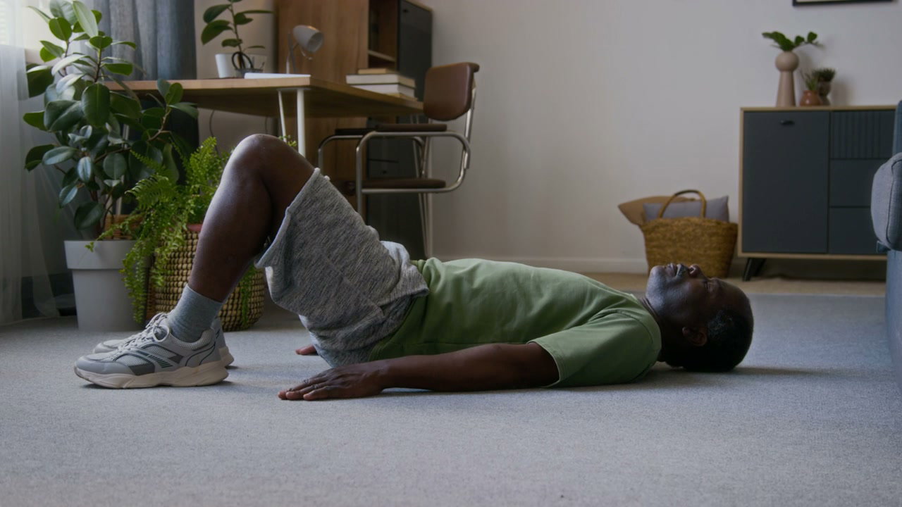Senior Man Performing Glute Bridge Exercise at Home
