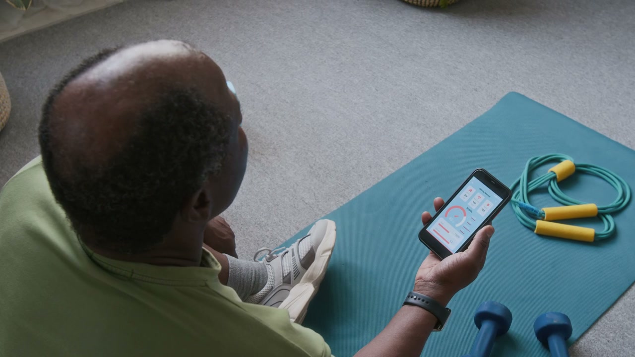 Senior Man Checking Fitness App on Smartphone
