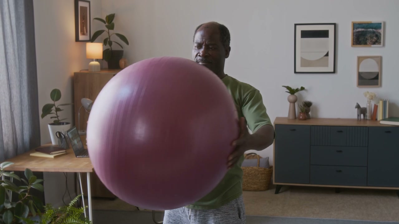 Senior Man Doing Torso Twists with Exercise Ball