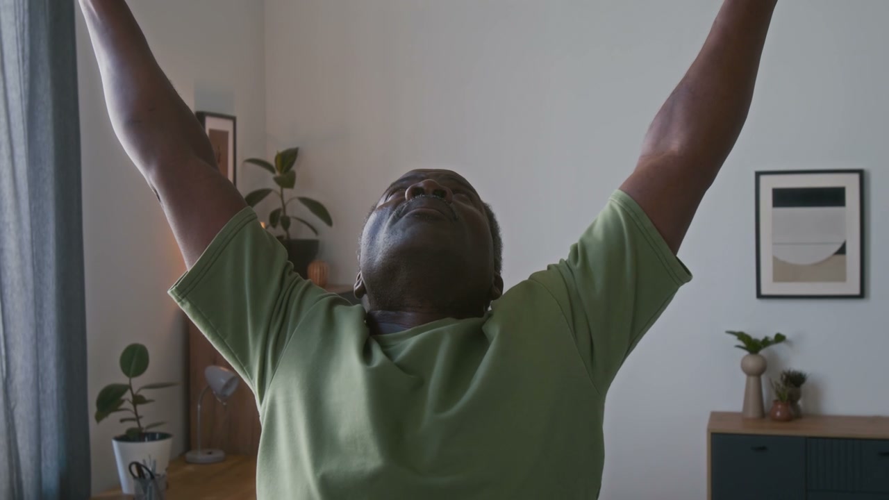 Smiling Senior Man Exercising with Towel