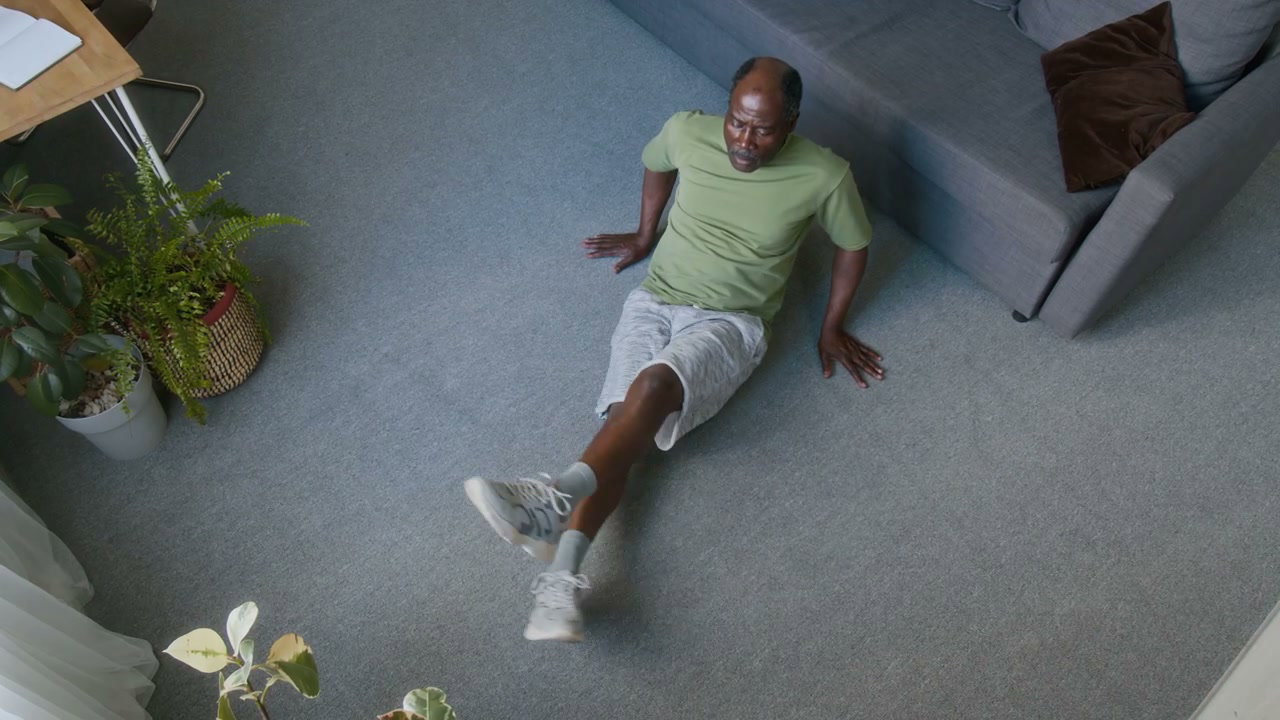 Senior Man Performing Scissor Kicks at Home