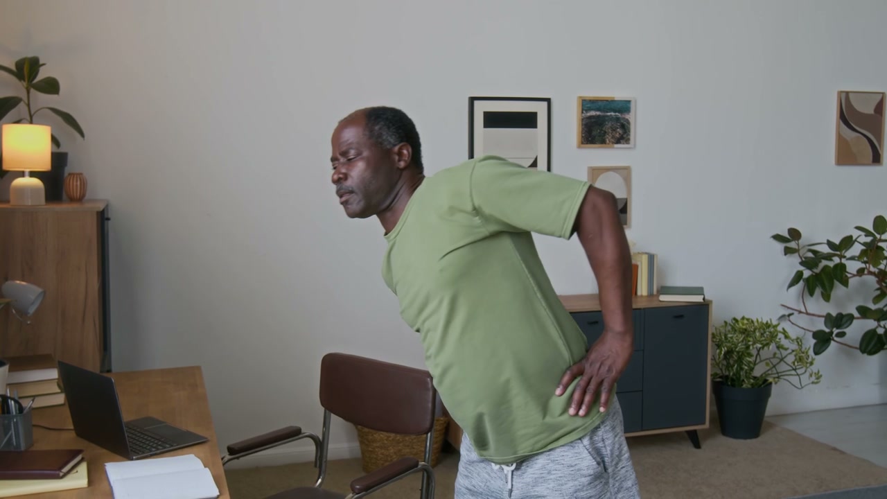 Elderly Man Doing Back Stretches
