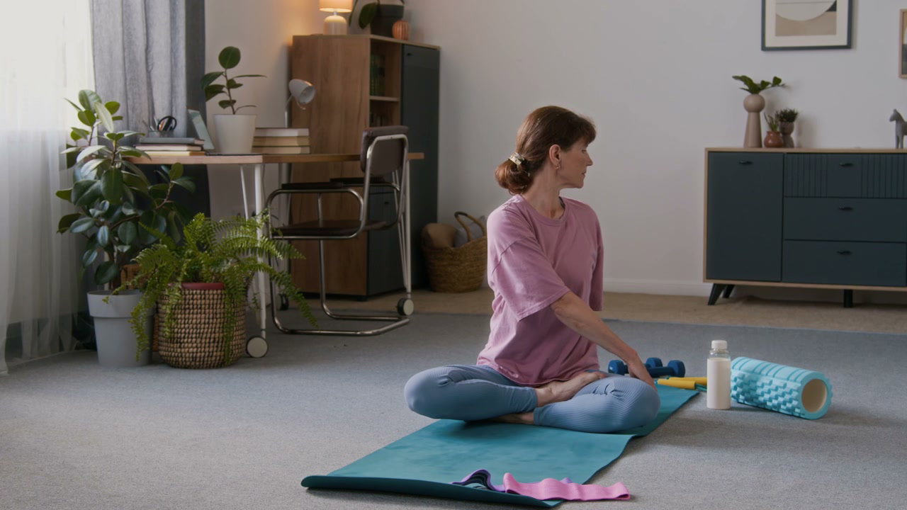 Senior Woman Stretching and Twisting in Living Room