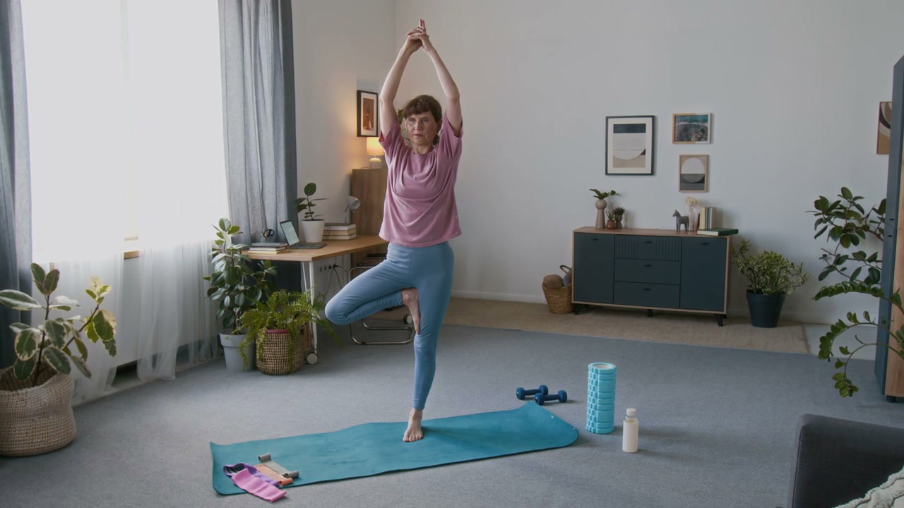 Senior Woman Doing Tree Pose Yoga at Home