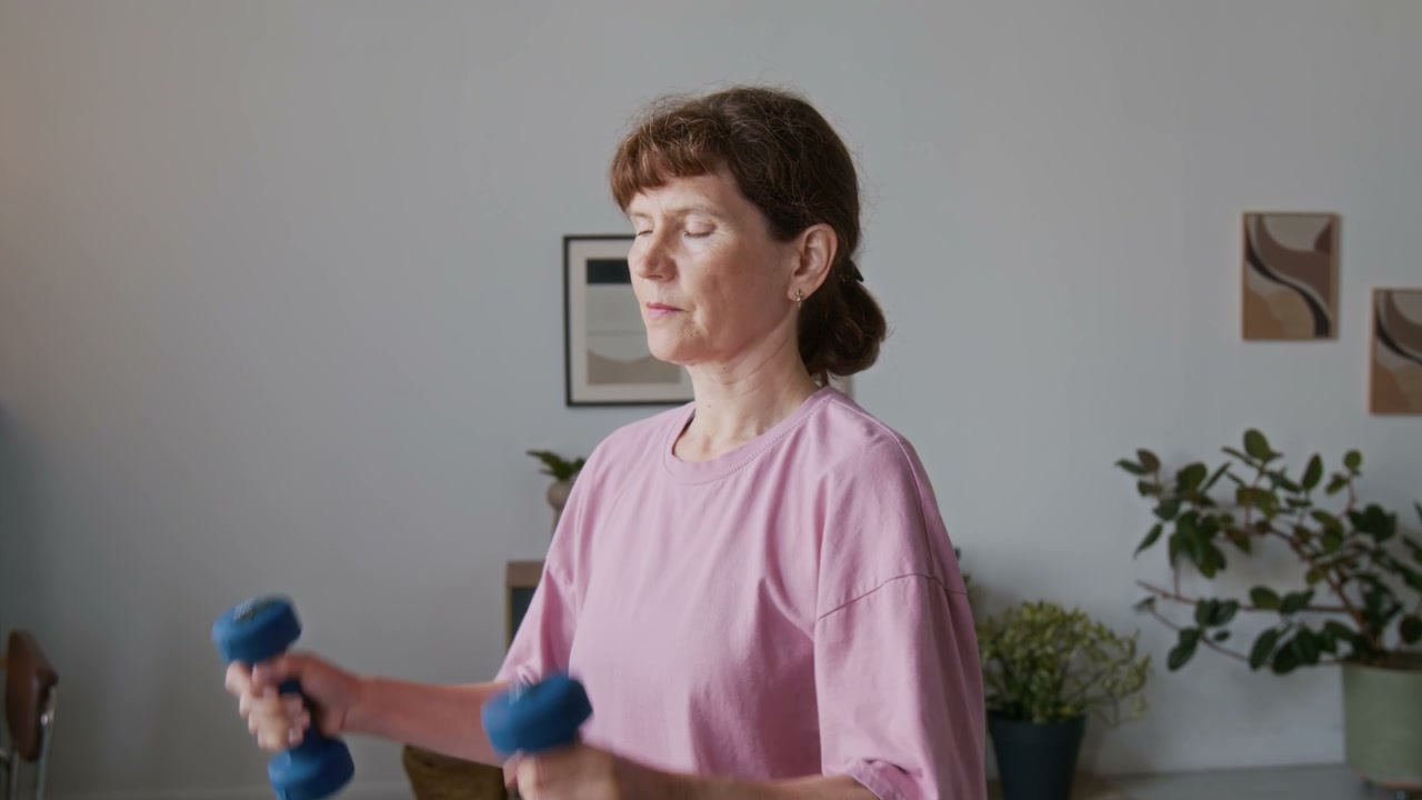Senior Woman Doing Dumbbell Lateral Raises