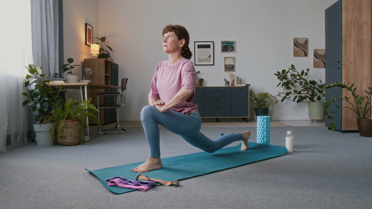 Senior Woman Doing Yoga Stretch At Home