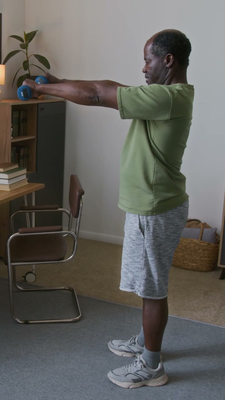 Senior Man Doing Dumbbell Exercises at Home