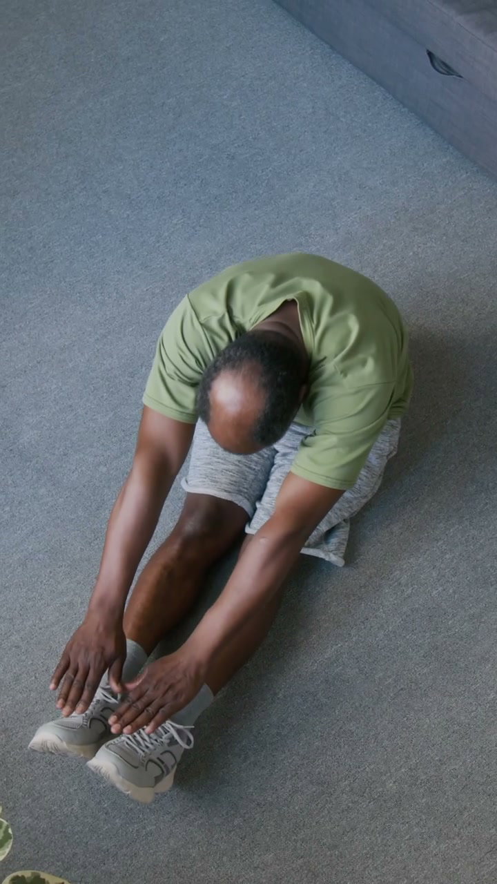 Senior Man Doing Floor Stretches