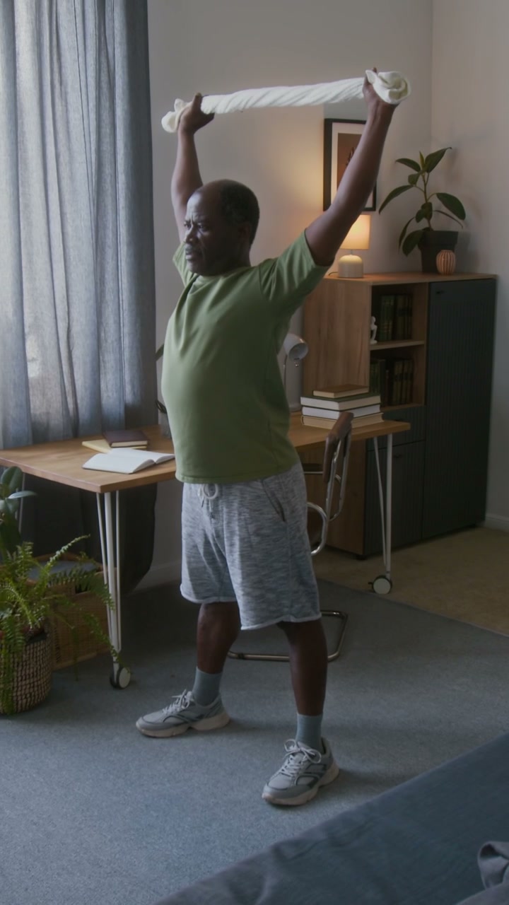 Senior Man Doing Shoulder Exercises at Home