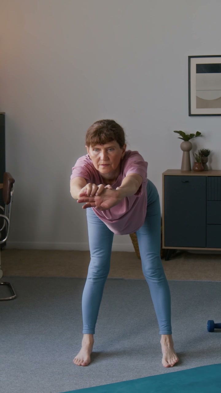 Senior Woman Stretching and Bending at Home