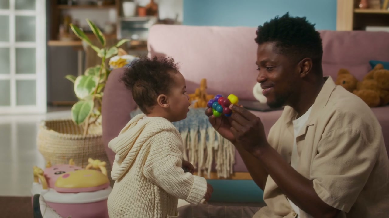 Father and Baby Play with Toy at Home