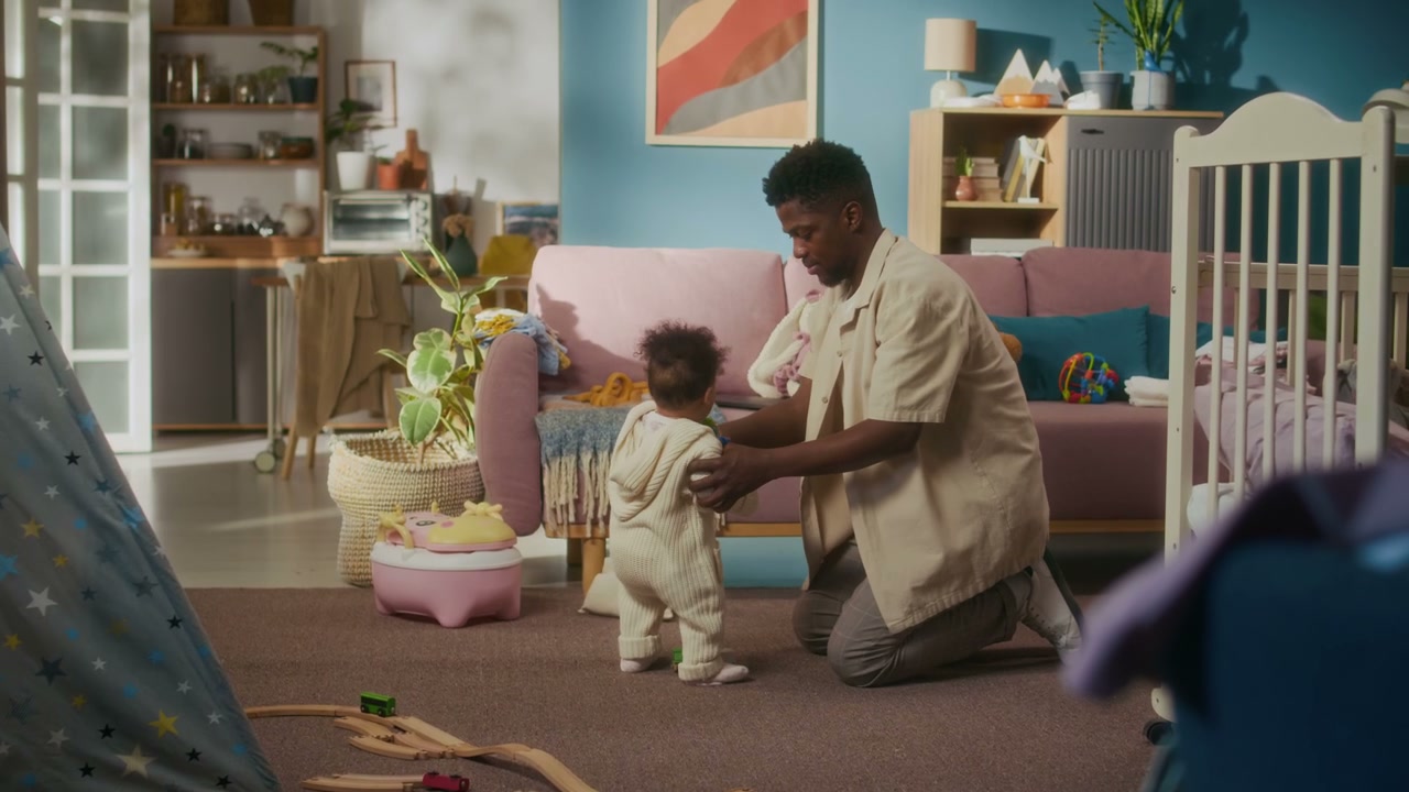 Caring Father Helps Baby Learn to Walk