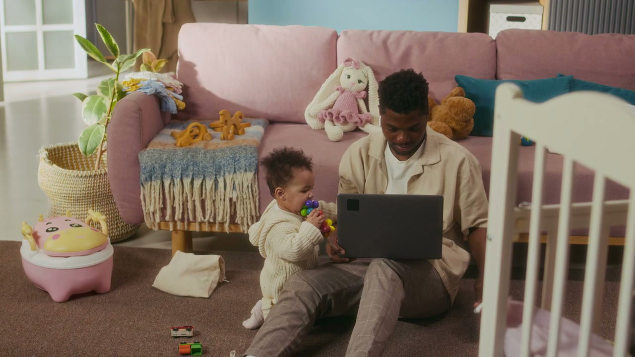 Dad Working on Laptop with Toddler at Home