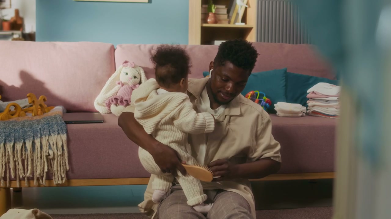 Father Brushing Baby Girl's Hair