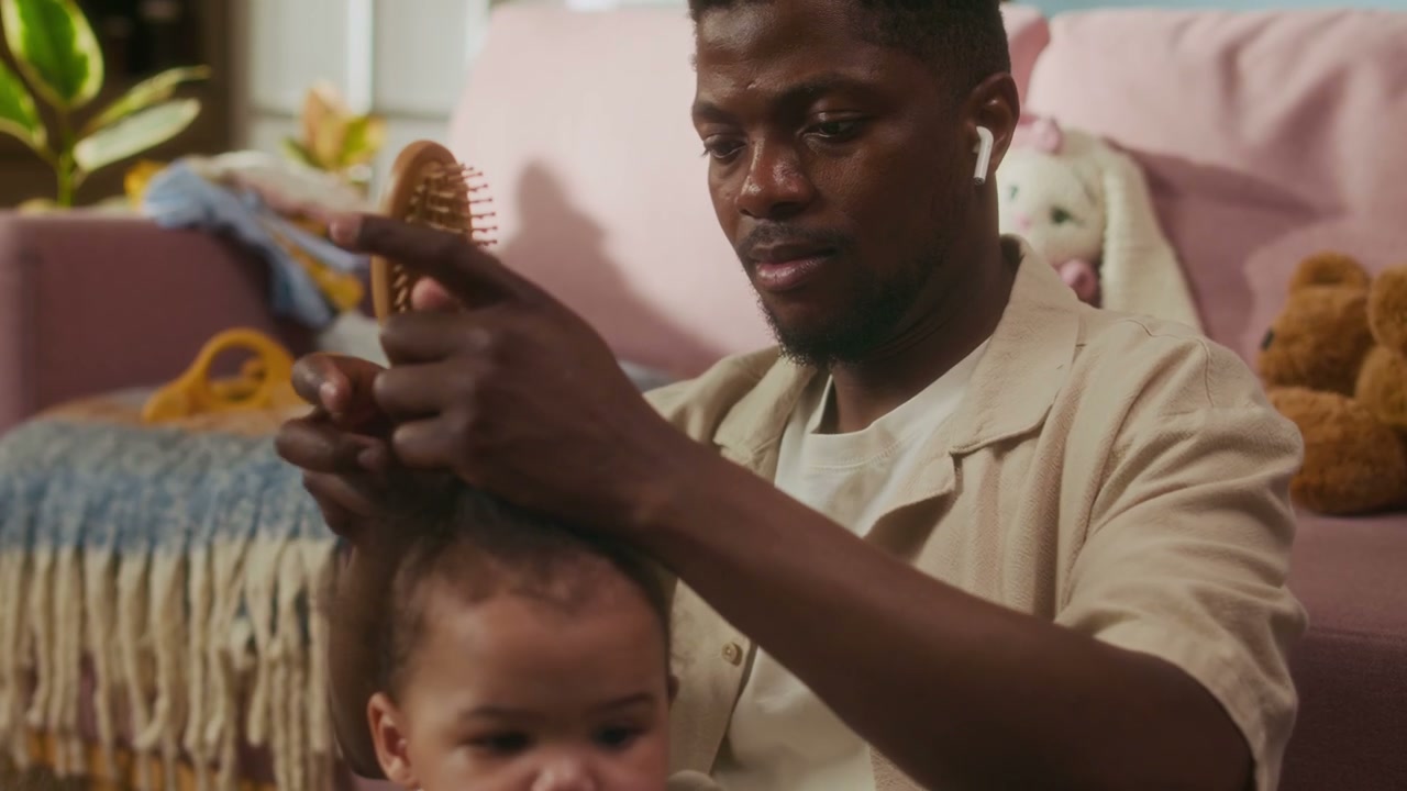Father Brushing Daughter's Hair