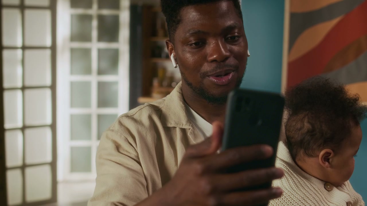 Man Holding Baby on Video Call