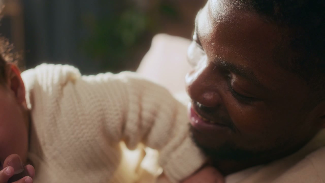 Black Father and Baby Playing Indoors