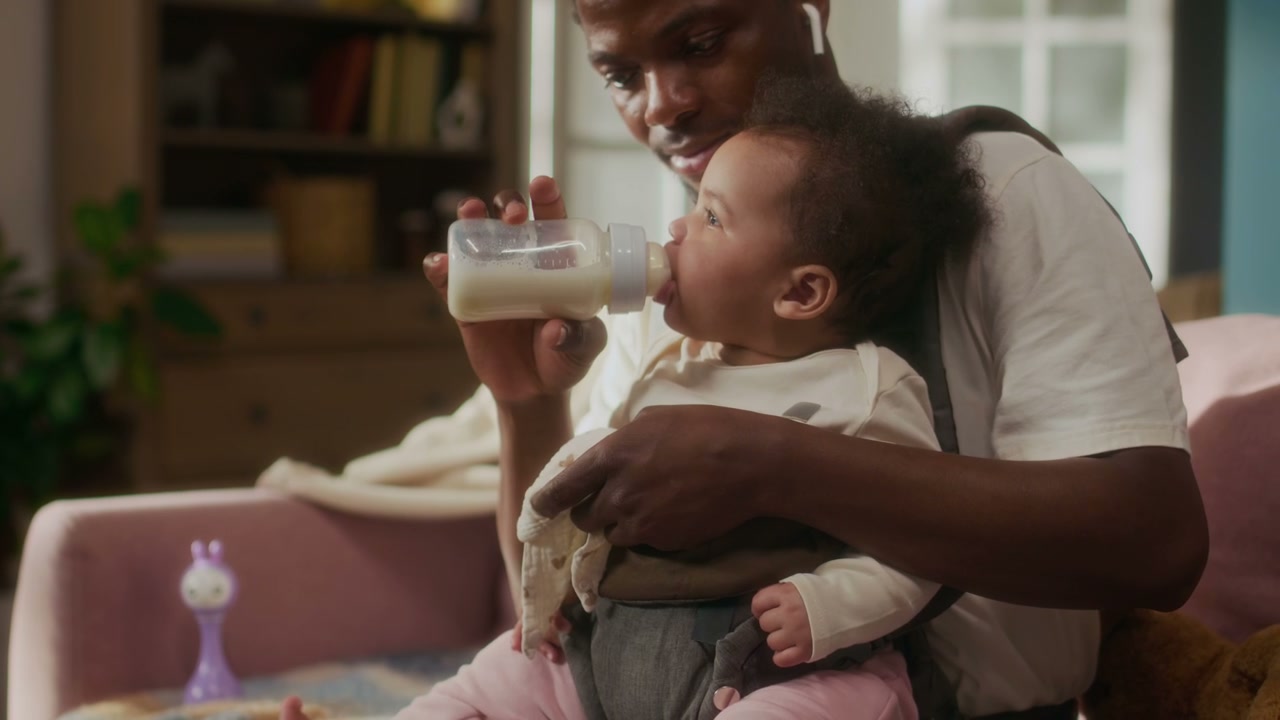 Father Feeding Baby from Bottle