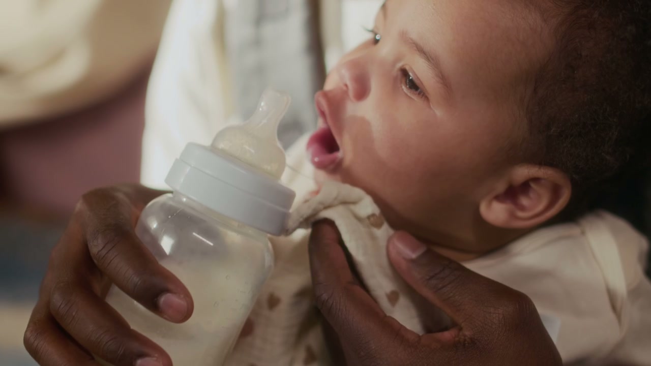 Parent Bottle Feeding Infant Close-Up