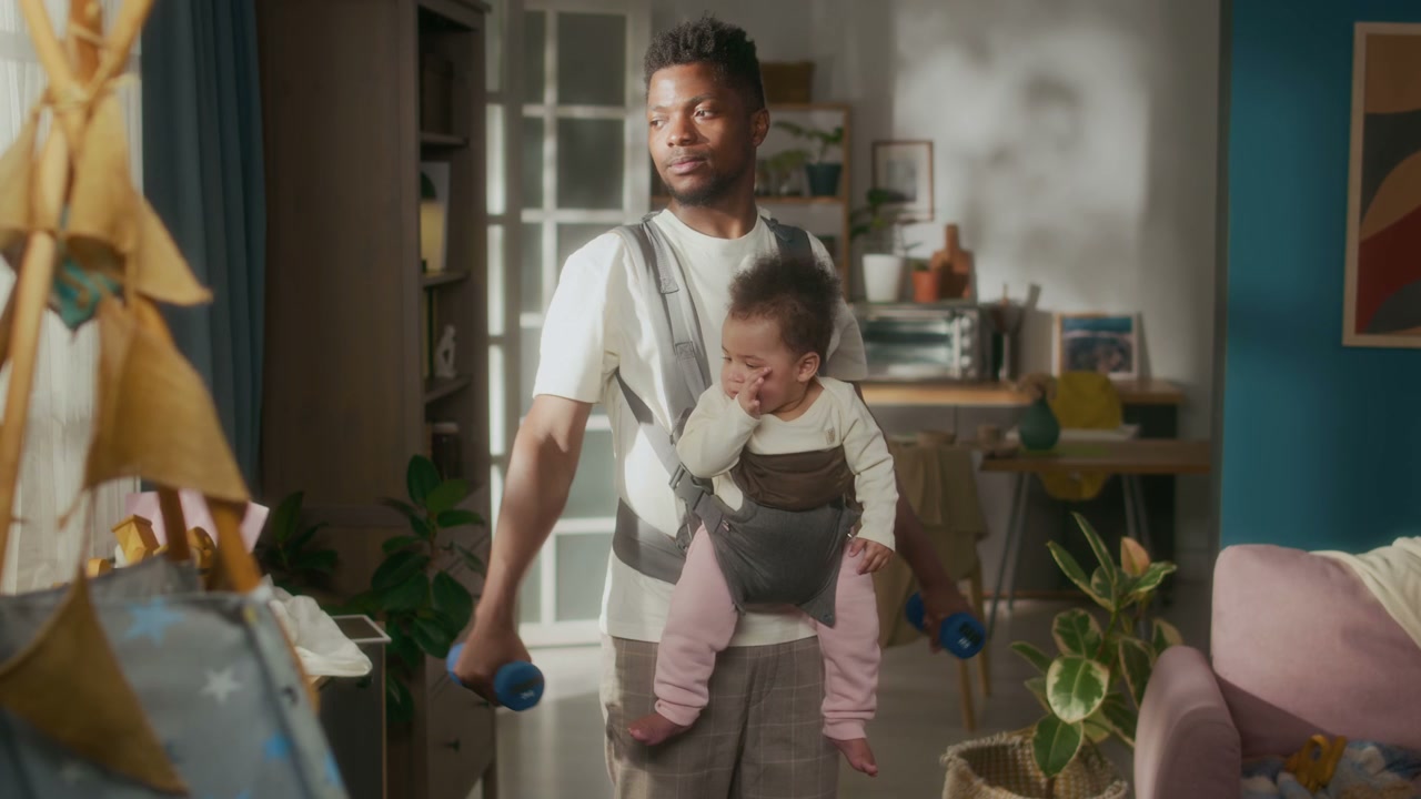 Father Working Out With Baby In Carrier