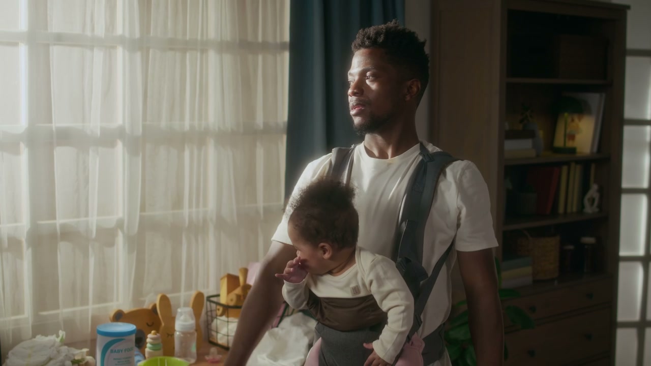 Dad Exercising with Baby in Carrier at Home