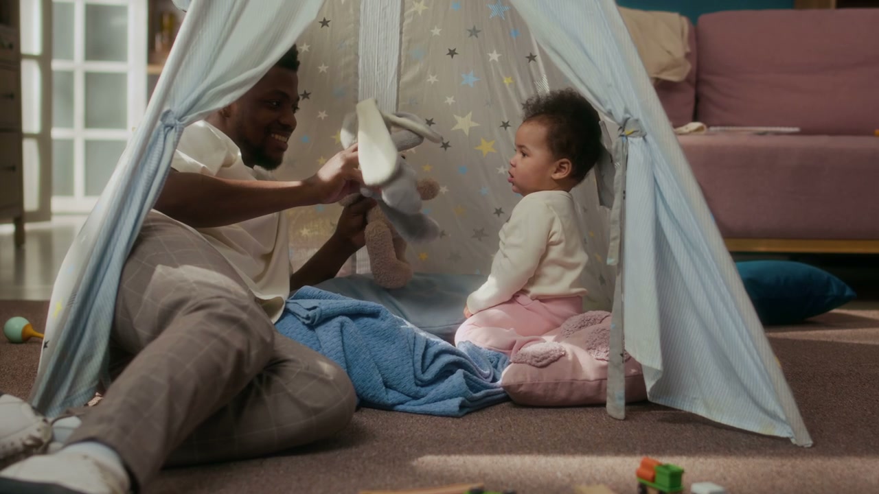 Happy Dad and Baby Play in Teepee