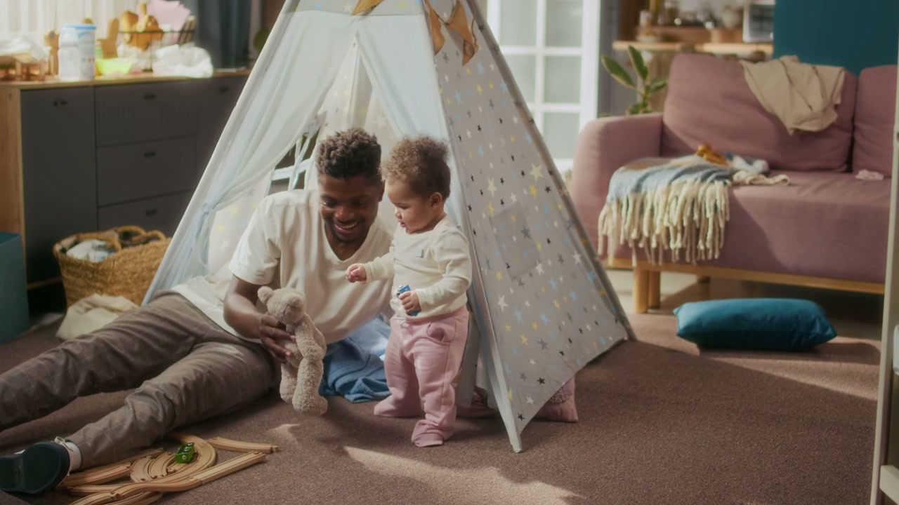Father and Baby Playing by Teepee Tent